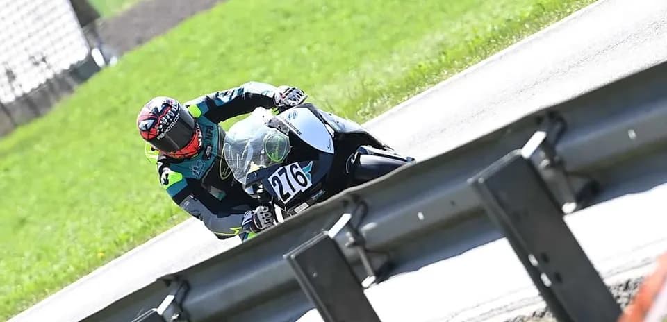 Motorcyclist leaning into a turn on racetrack