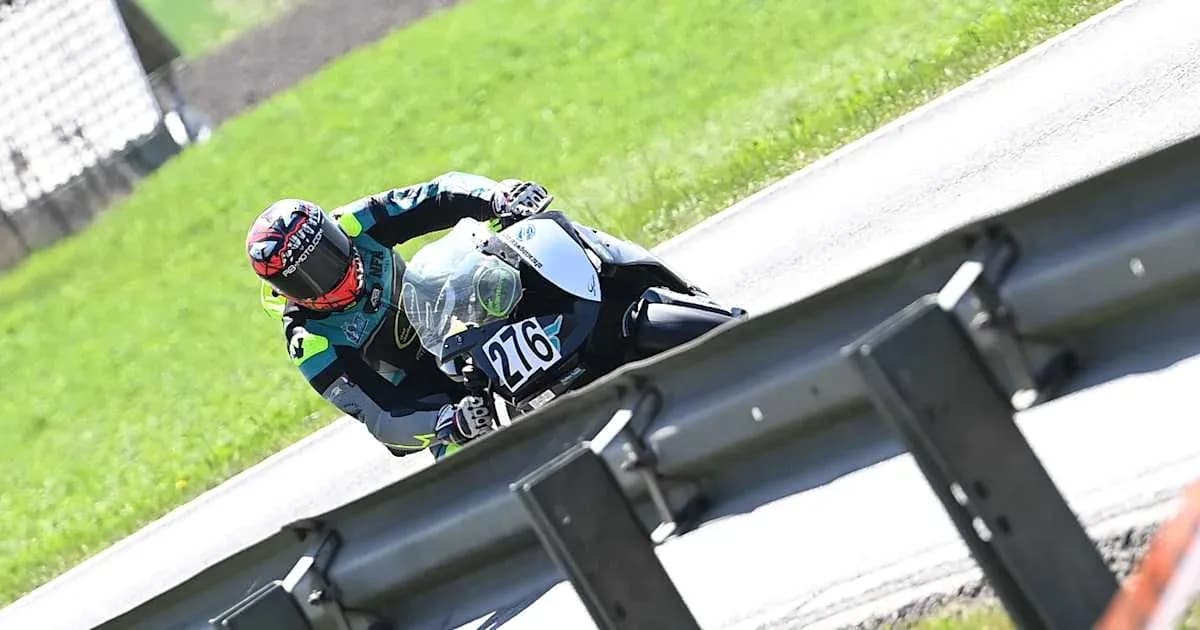 Motorcyclist leaning into a turn on racetrack