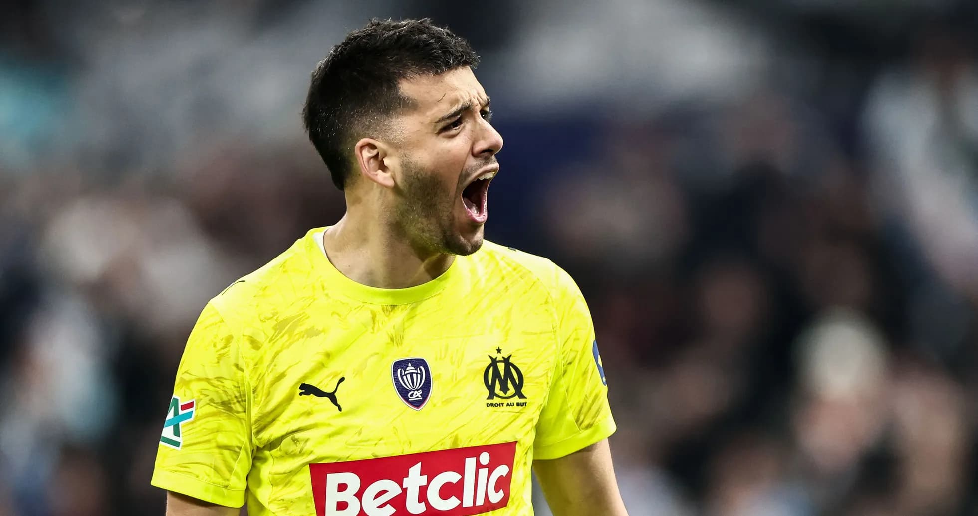 Goalkeeper in yellow jersey celebrating during match