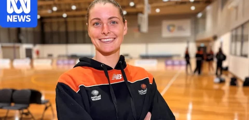 Netball player posing in training facility