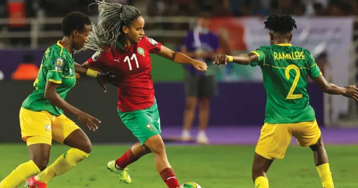 Morocco player dribbling past two opponents in match
