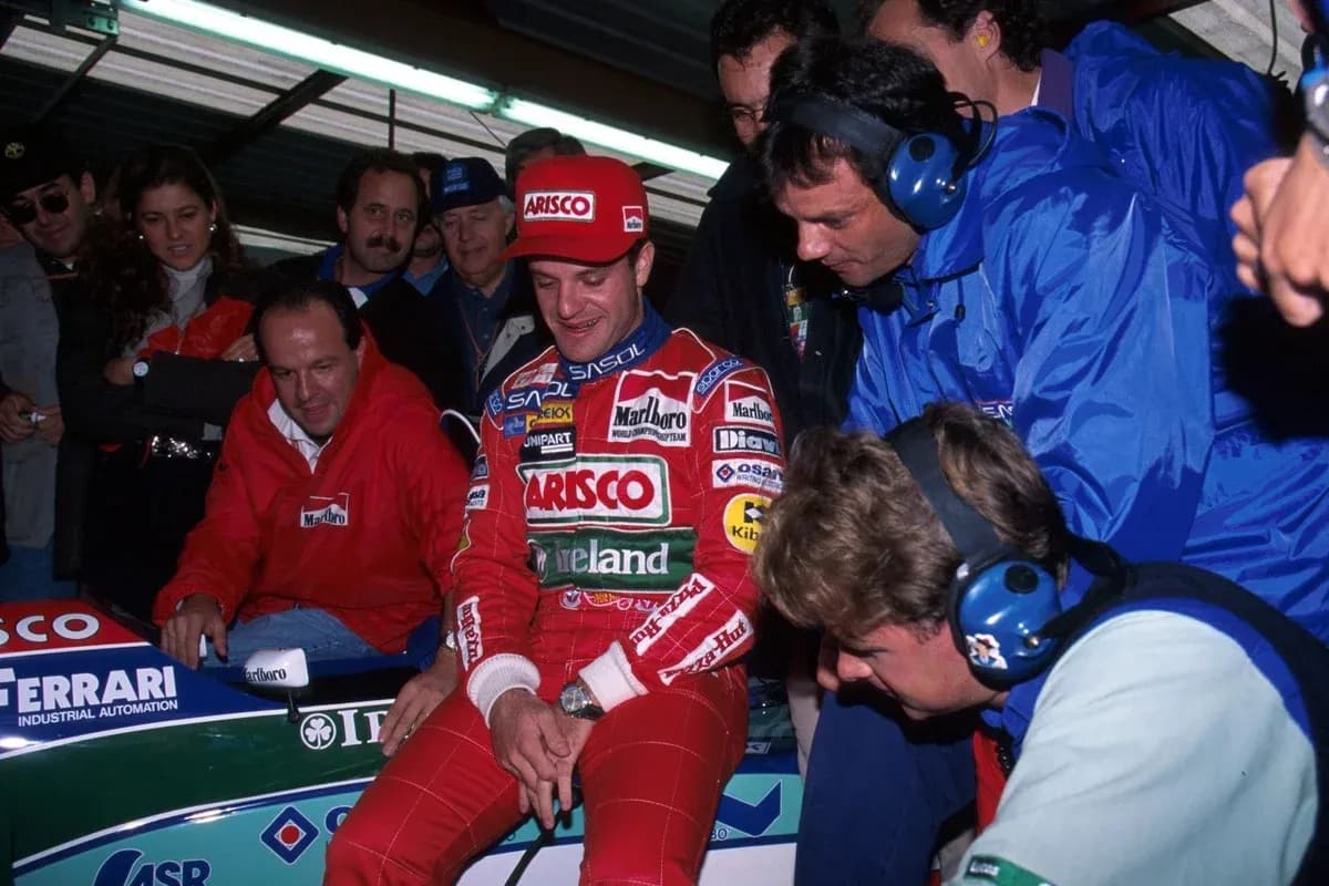 F1 driver with team members near racing car