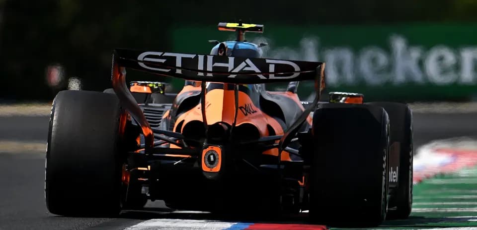 F1 car racing on track with colorful curbing