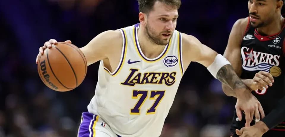 Lakers player dribbling past defender during game