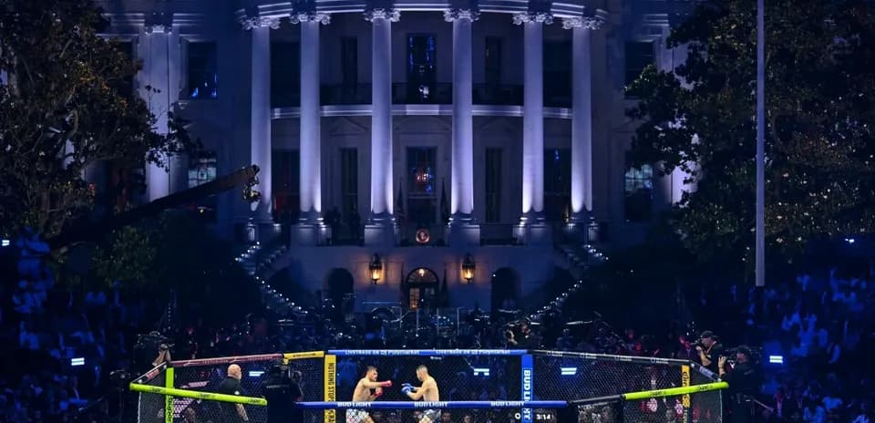 Two fighters competing in octagon outside building
