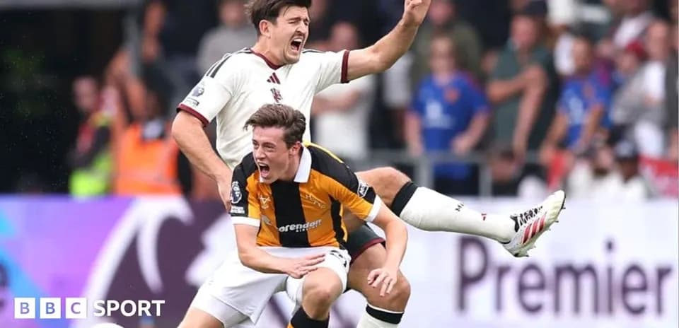 Two players in a tackle during a football match