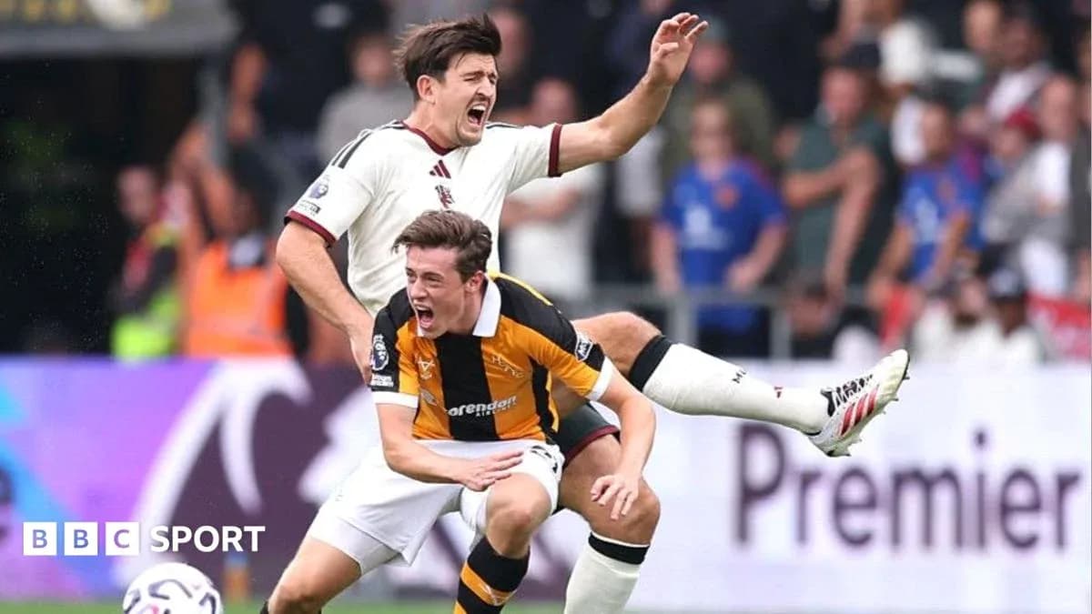 Two players in a tackle during a football match