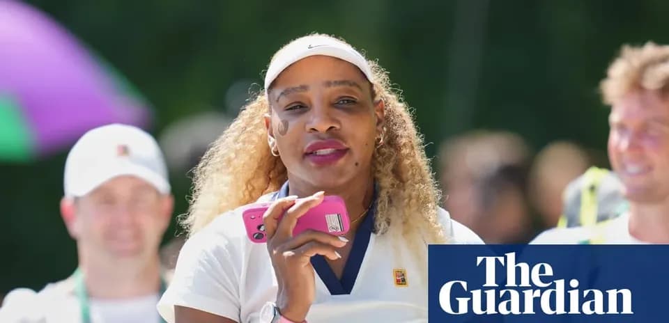 Tennis player holding phone during outdoor event