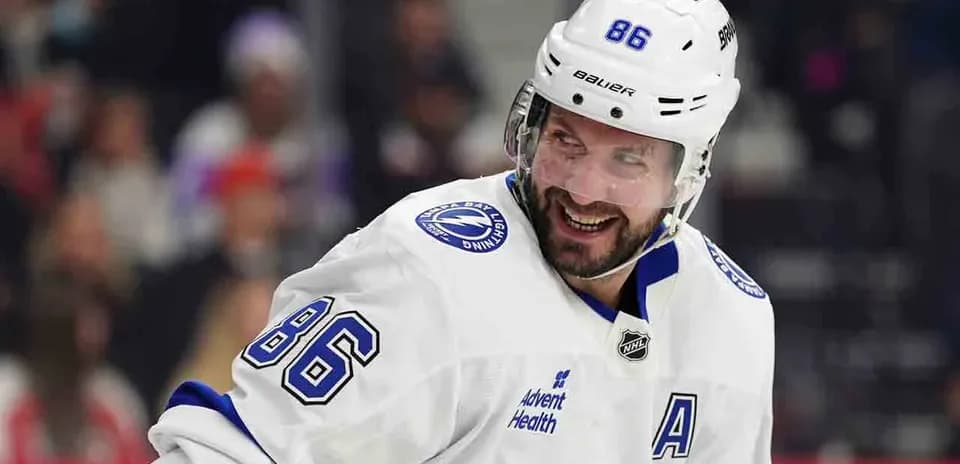 Hockey player smiling during game in white jersey