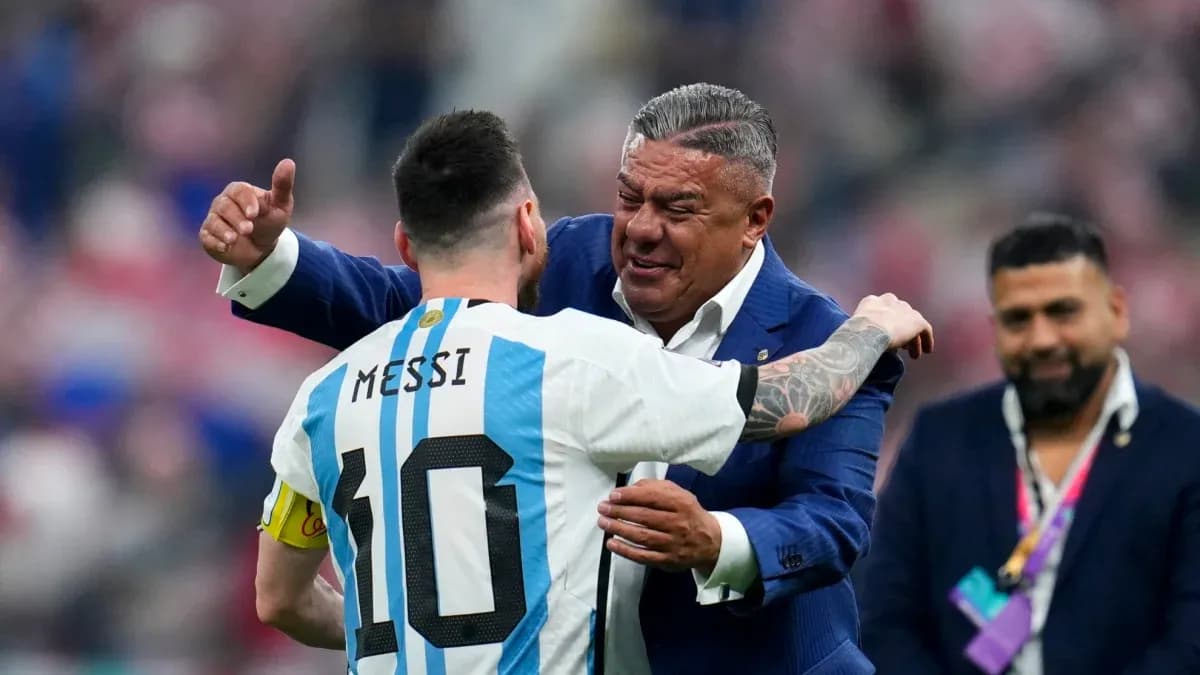 Lionel Messi embracing a man in a suit