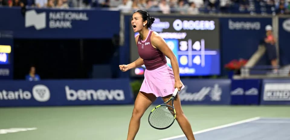 Tennis player celebrating victory on court