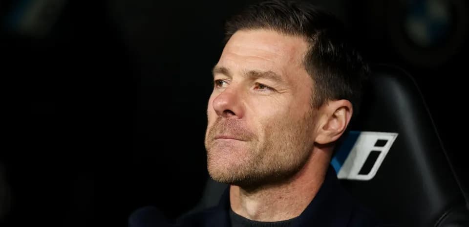 Football manager seated on the bench during match