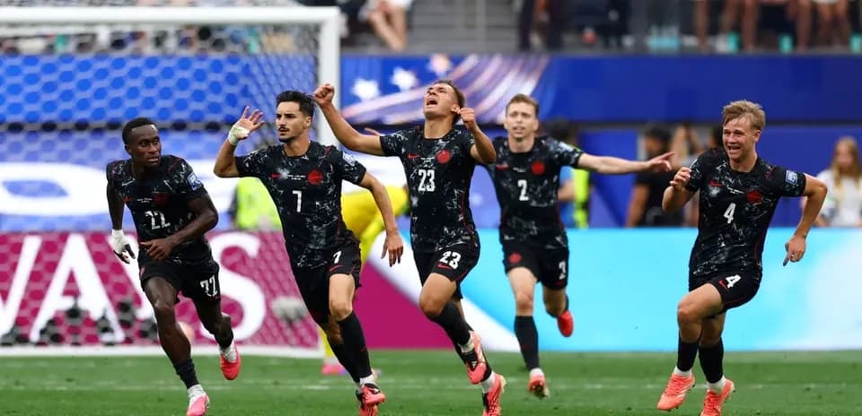 Football players celebrating a goal on the field