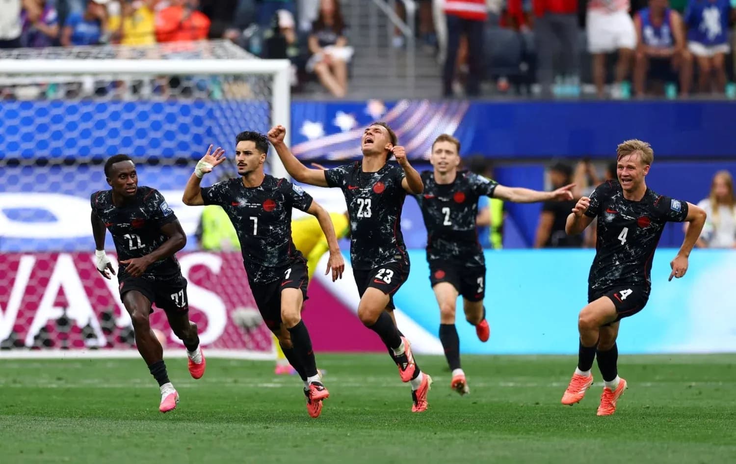 Football players celebrating a goal on the field