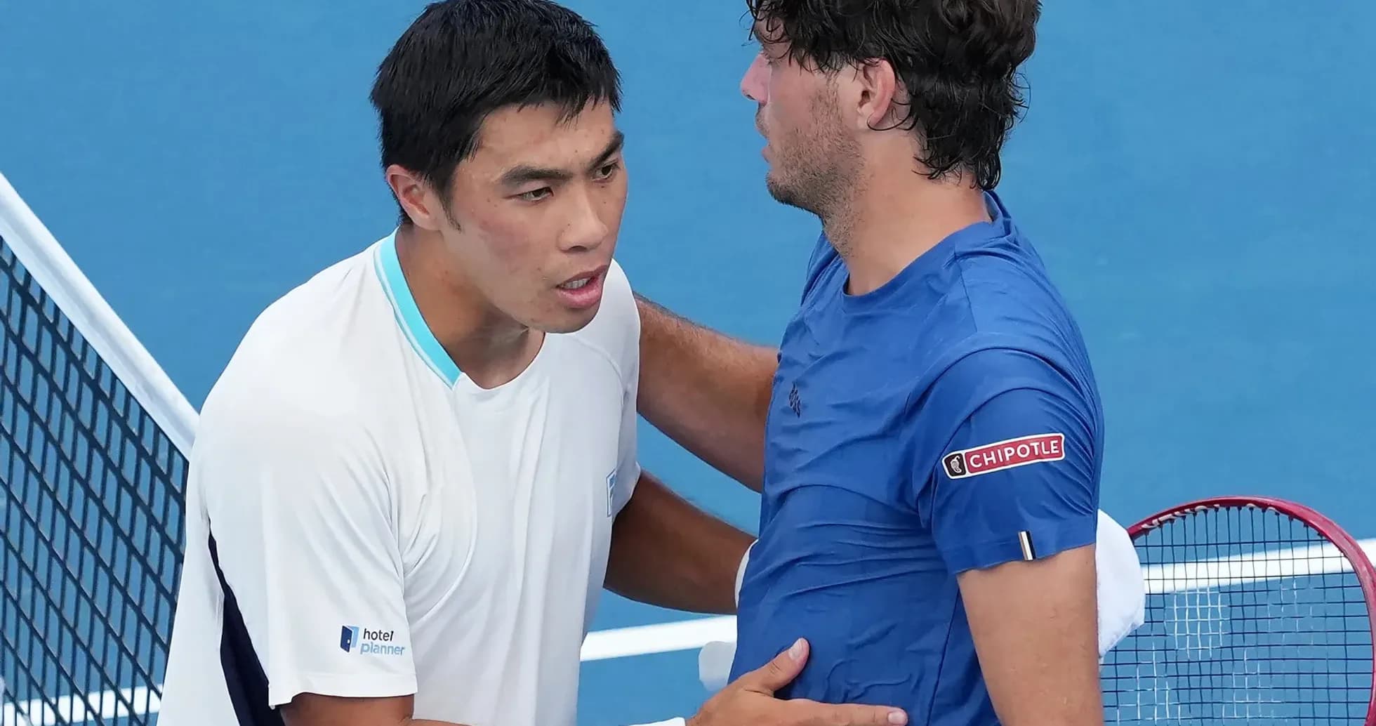 Tennis players shaking hands at net after match