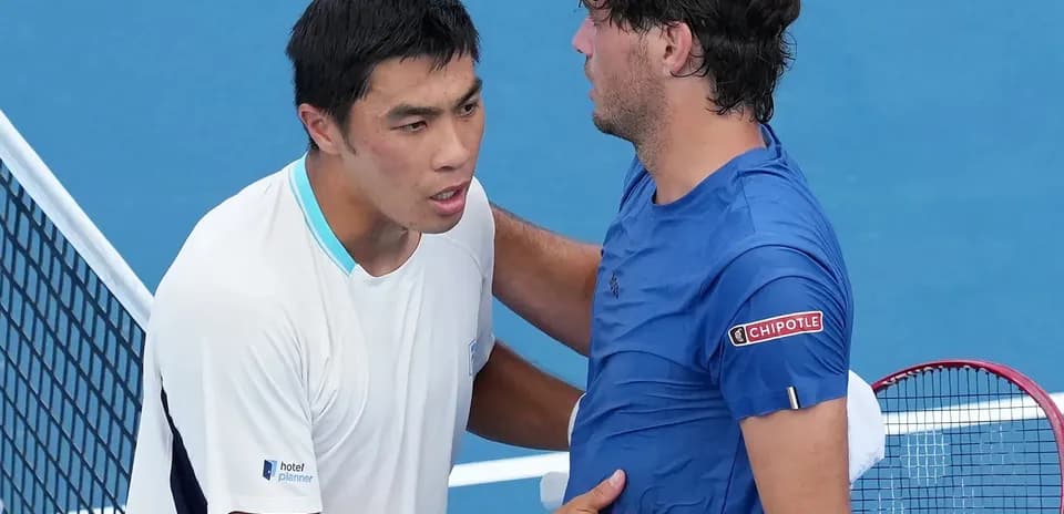 Tennis players shaking hands at net after match