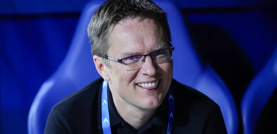 Man smiling in a sports venue seating area