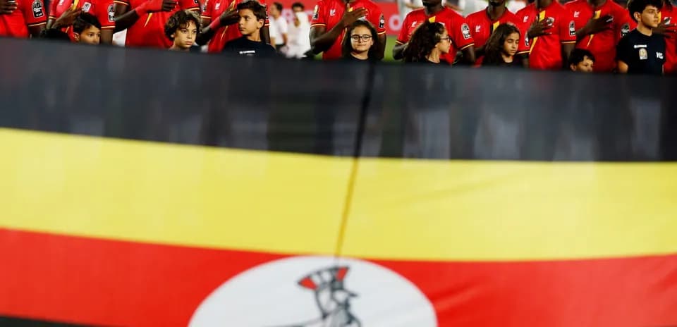 Ugandan team standing with flag before match