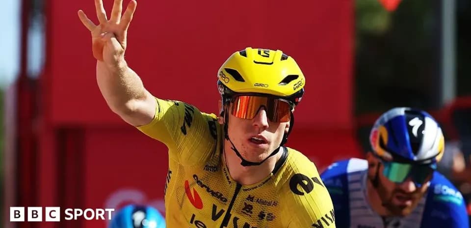 Bicycle racer in yellow jersey celebrating victory