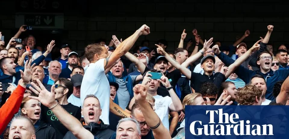 Fans cheering enthusiastically in a crowded stadium