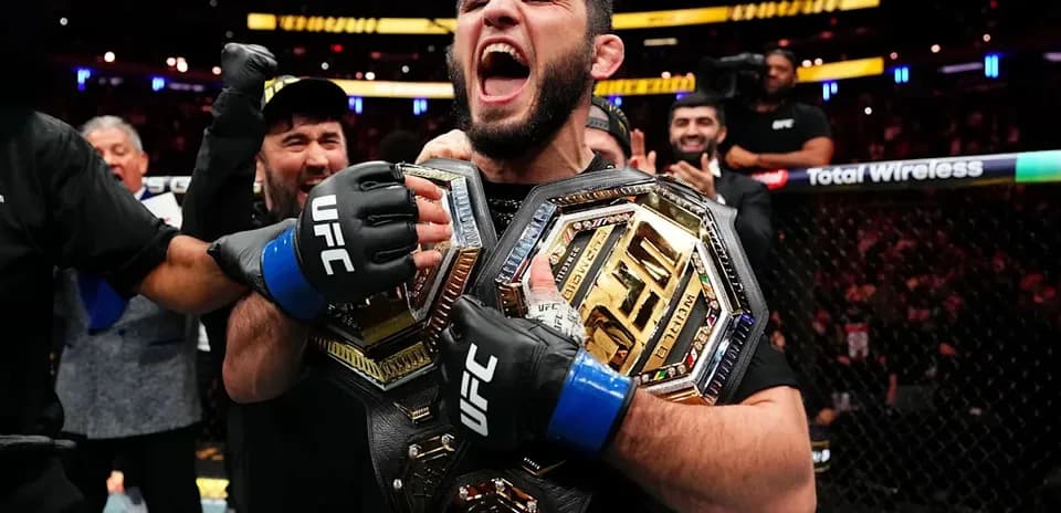 UFC champion celebrating with two championship belts