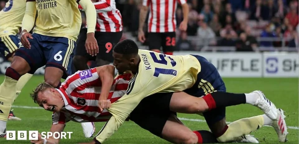 Two players struggling for the ball during match