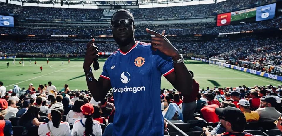 Fan wearing Manchester United jersey at stadium