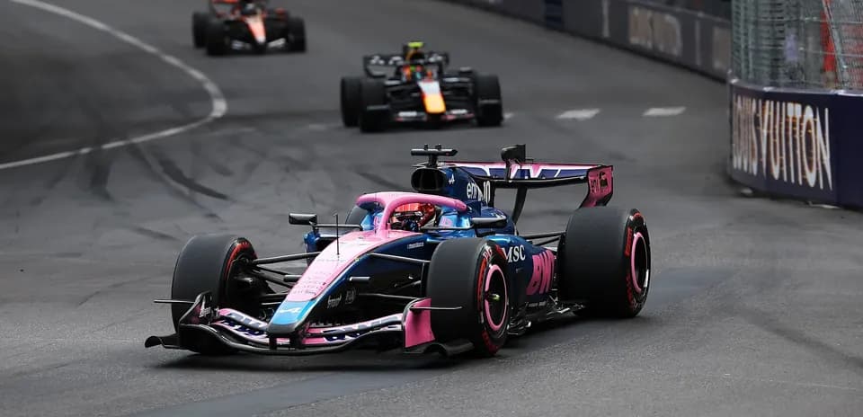 Formula 1 car racing around a corner on track