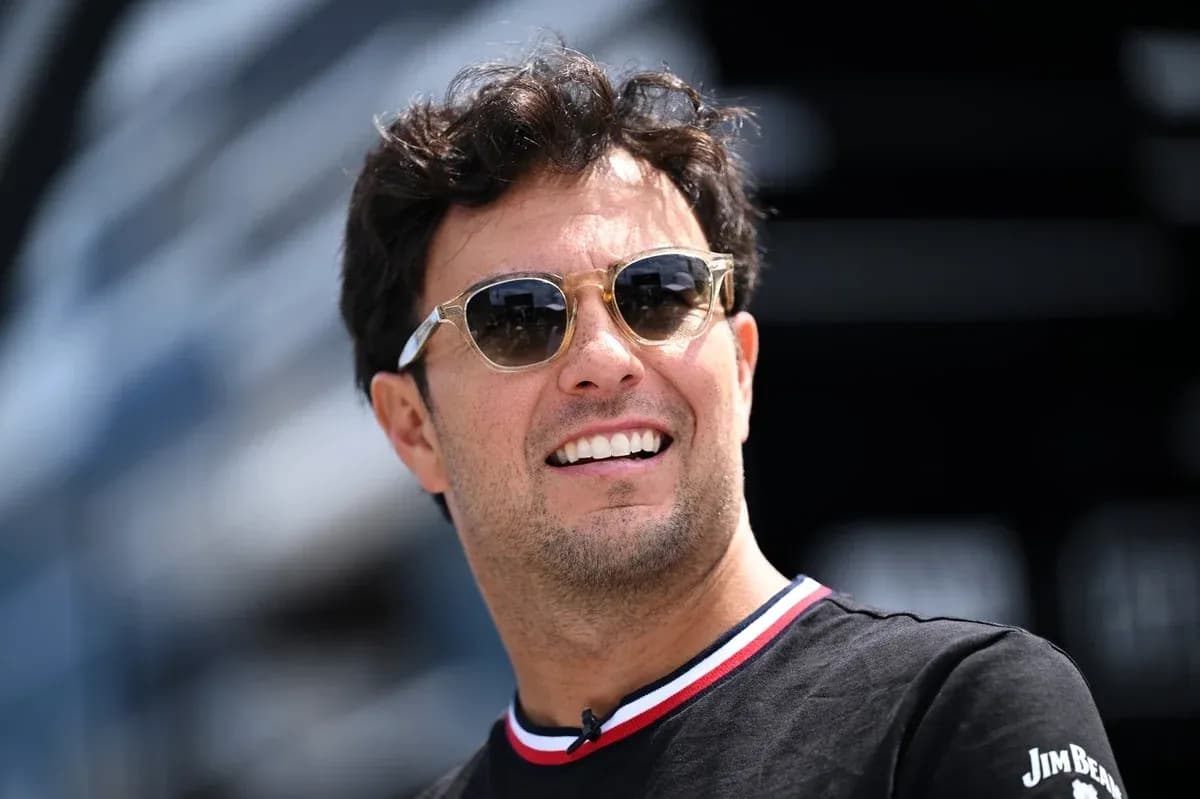 Shirtless man wearing sunglasses smiling outdoors