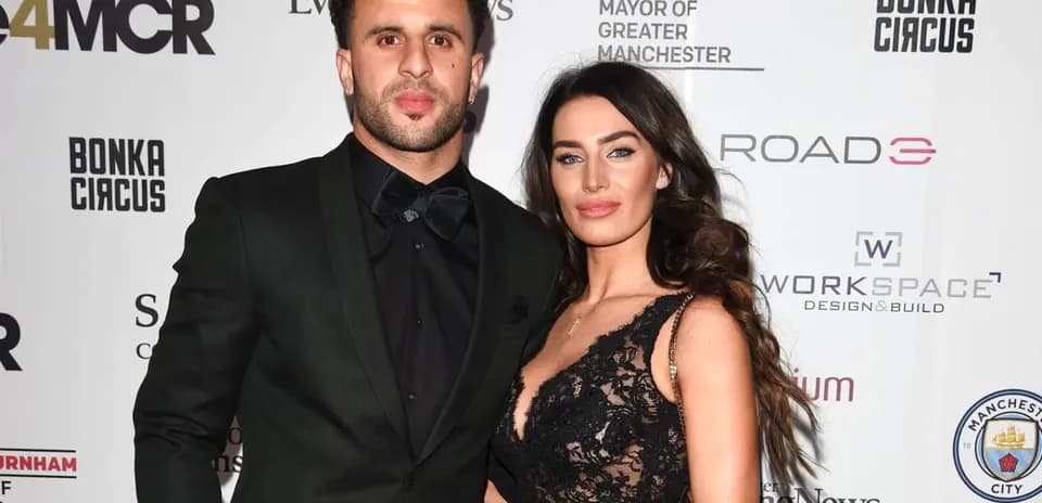 Couple posing at an event with a backdrop