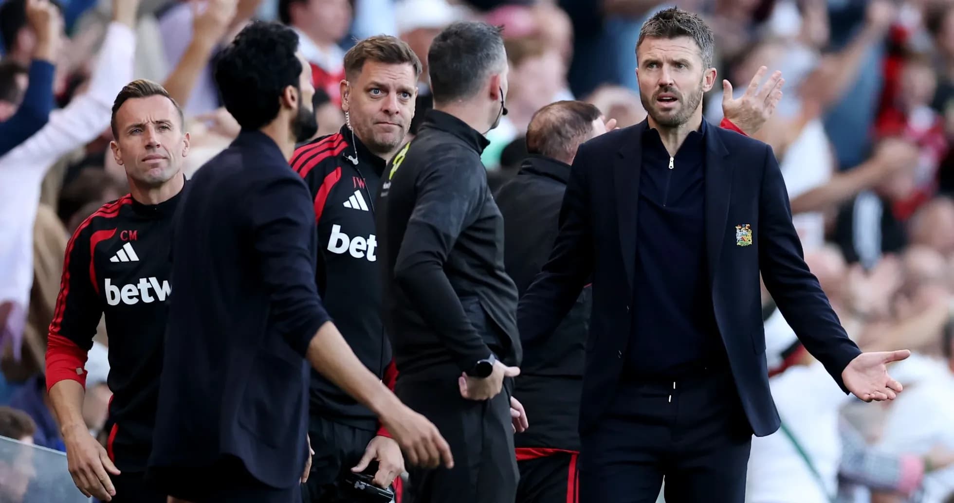 Coaching staff reacting during a match on sidelines