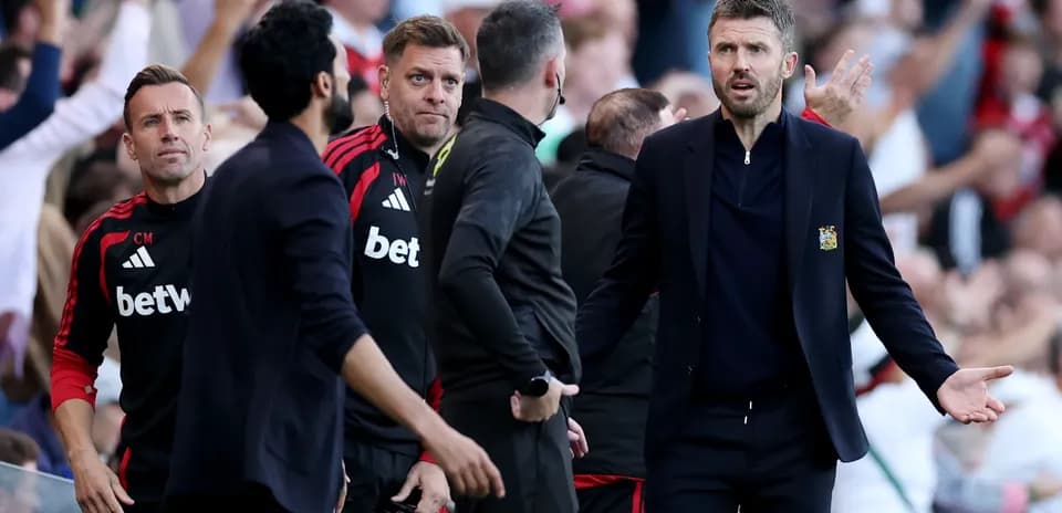 Coaching staff reacting during a match on sidelines