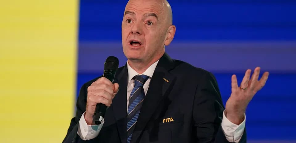 FIFA official speaking at a podium event