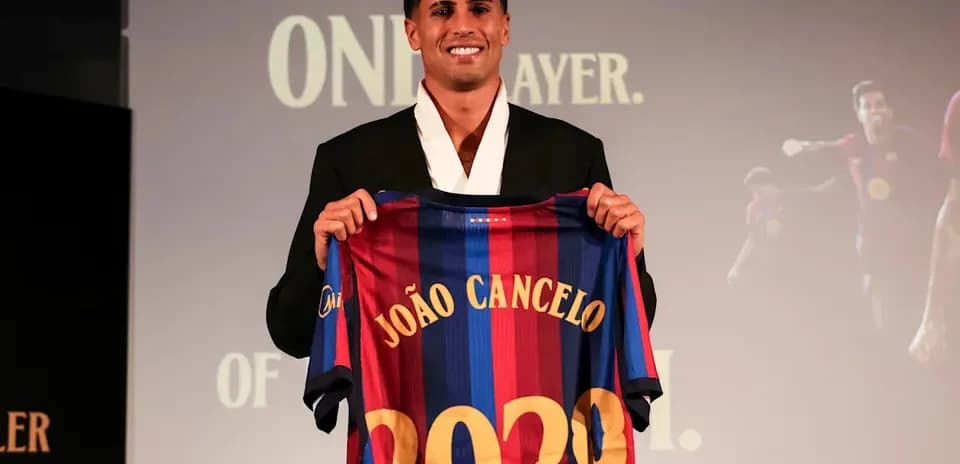 João Cancelo holding FC Barcelona jersey at presentation