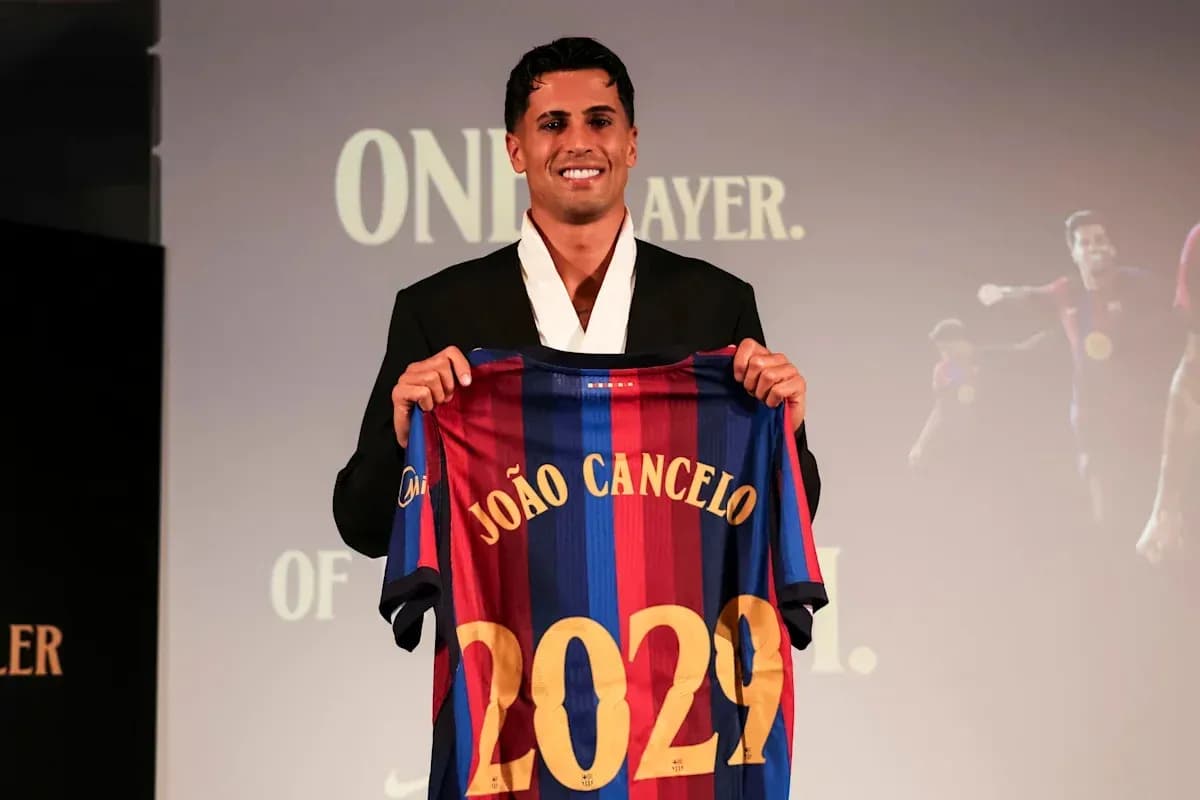 João Cancelo holding FC Barcelona jersey at presentation