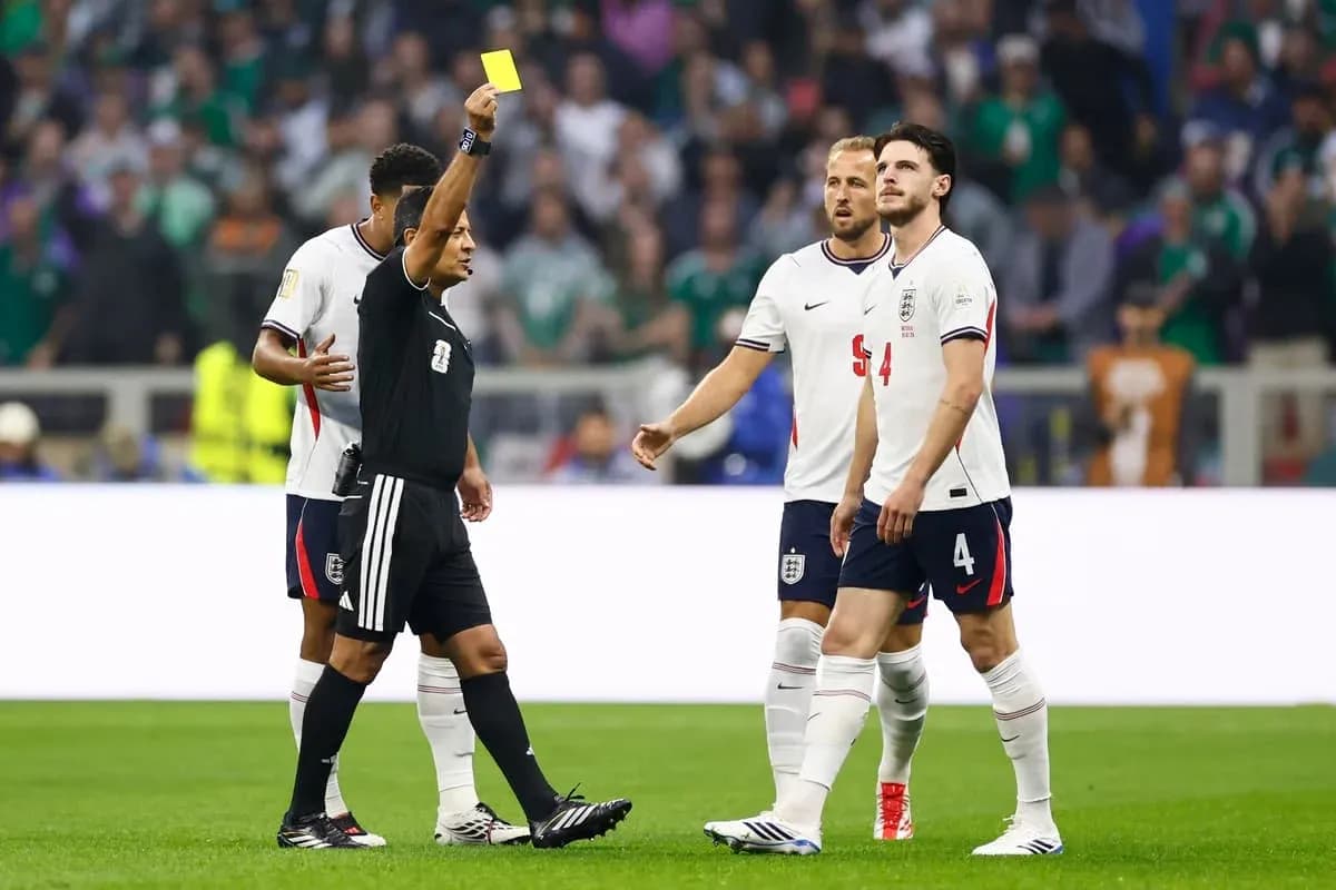Referee showing yellow card to England player