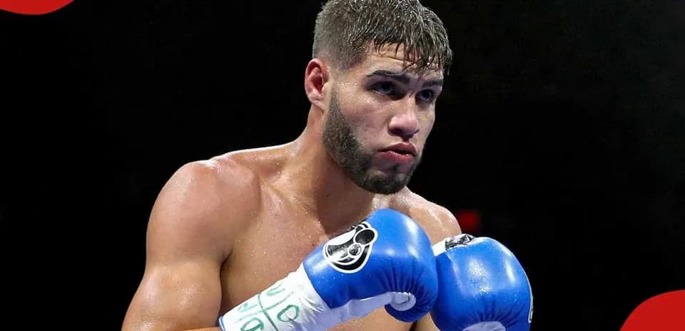 Boxer in blue gloves preparing for a match