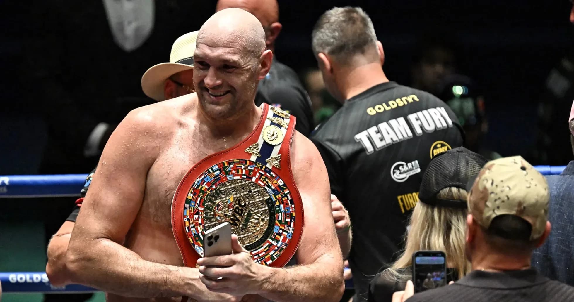 Boxer holding championship belt after victory