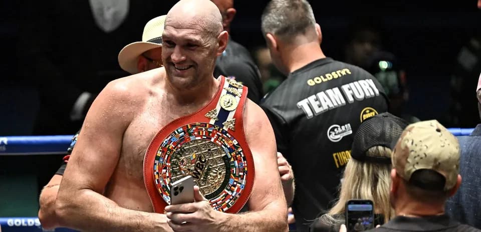 Boxer holding championship belt after victory