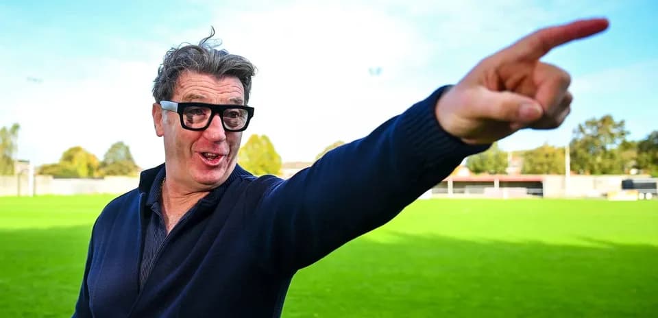 Man gesturing on a football field