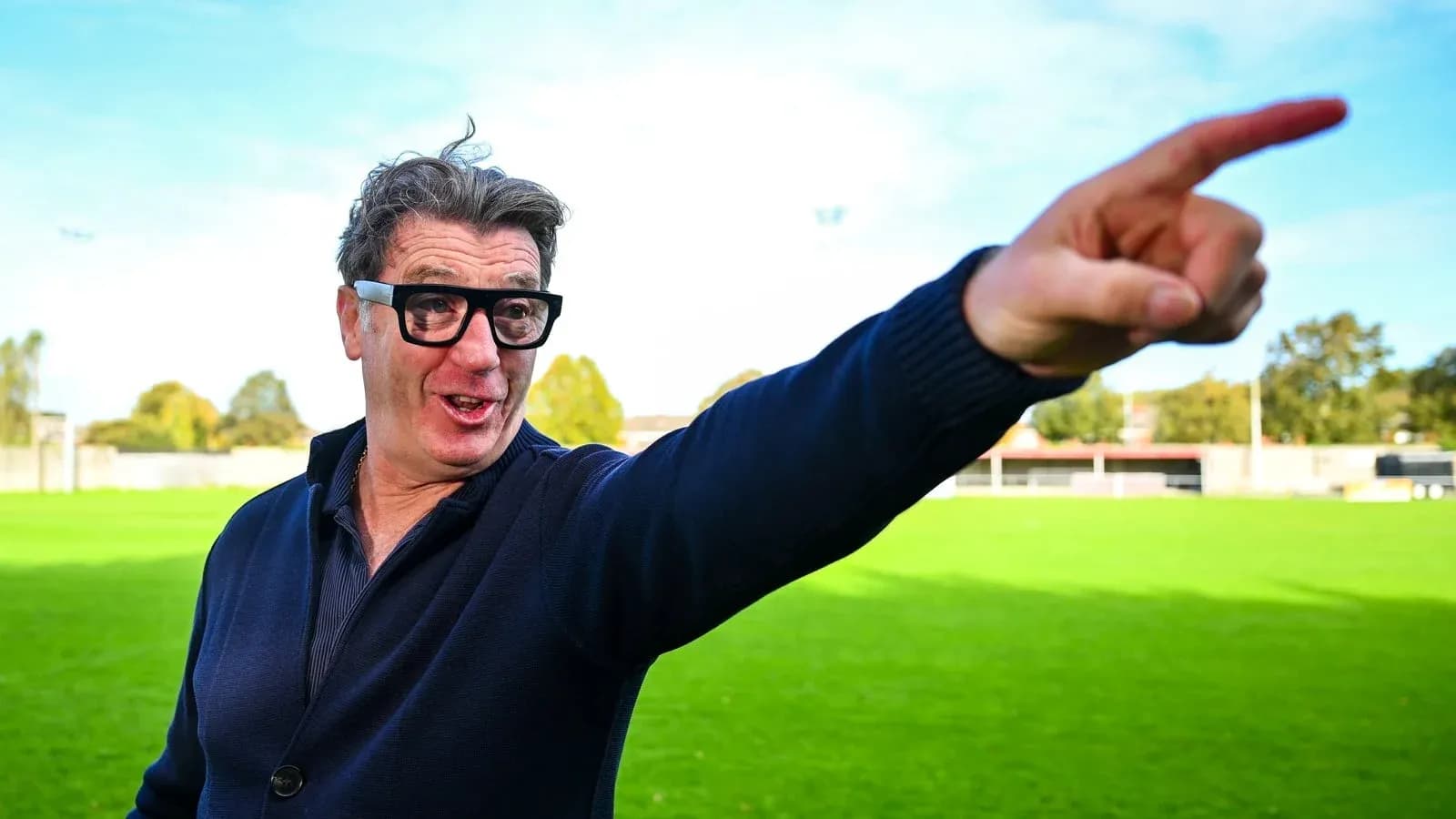 Man gesturing on a football field