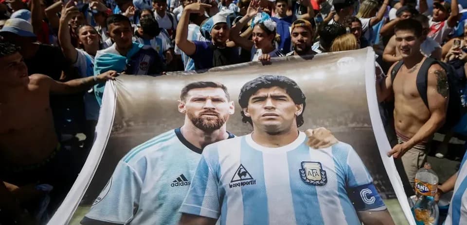 Fans holding banner of Messi and Maradona together