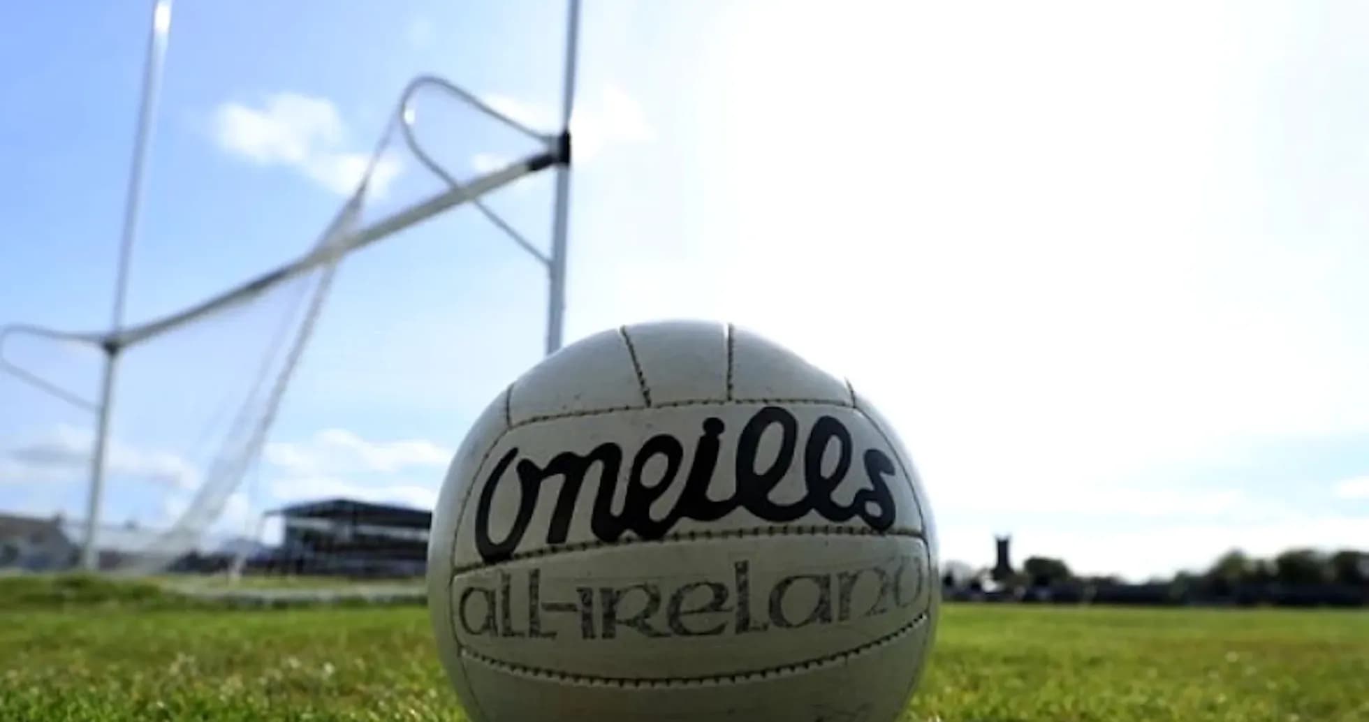 GAA football on field with goalposts in background