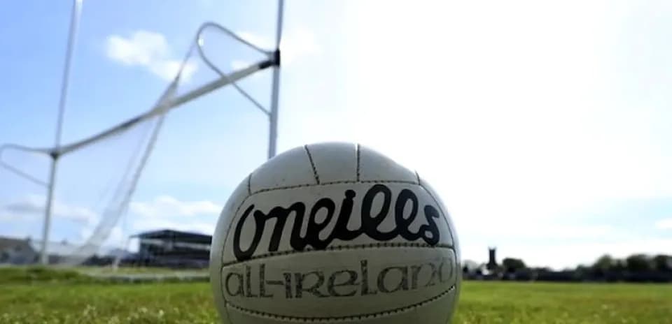 GAA football on field with goalposts in background