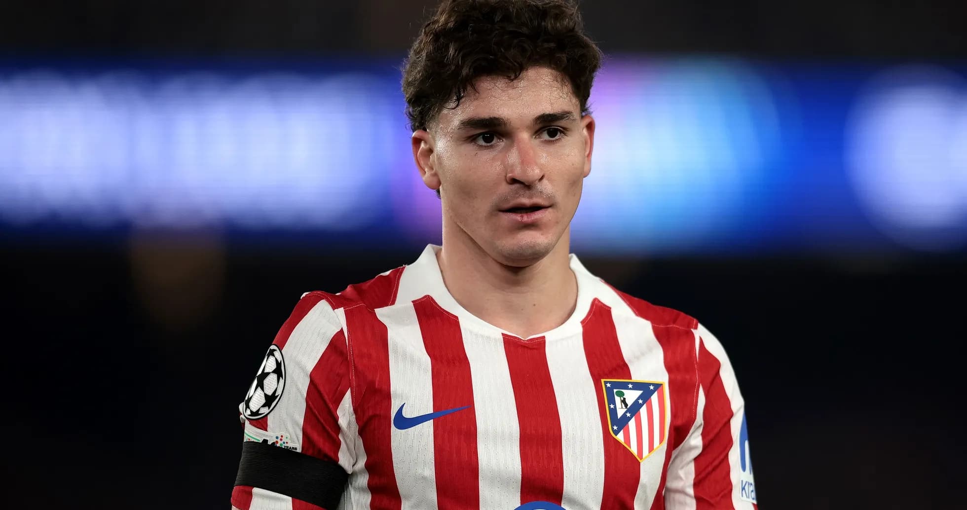 Atletico Madrid player wearing red and white jersey