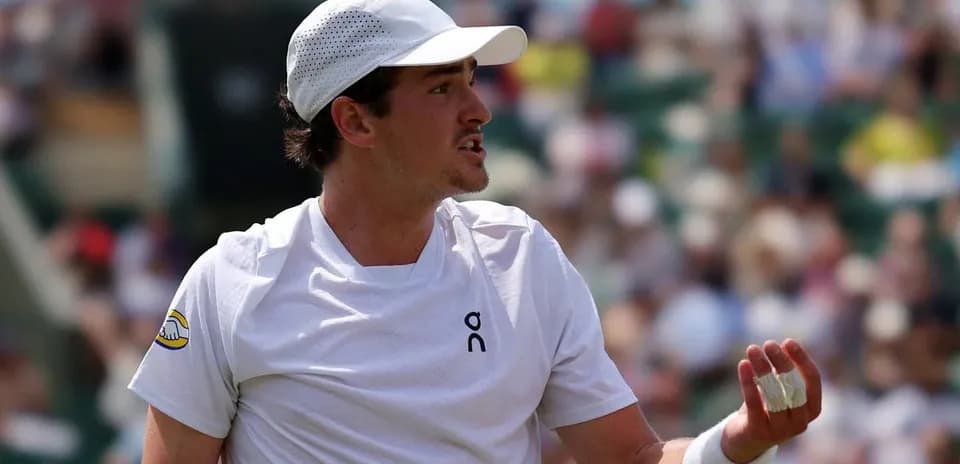 Tennis player gesturing during match on court