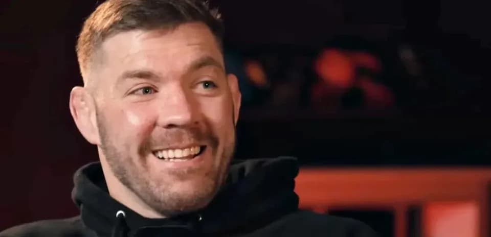Man smiling during an interview with microphone