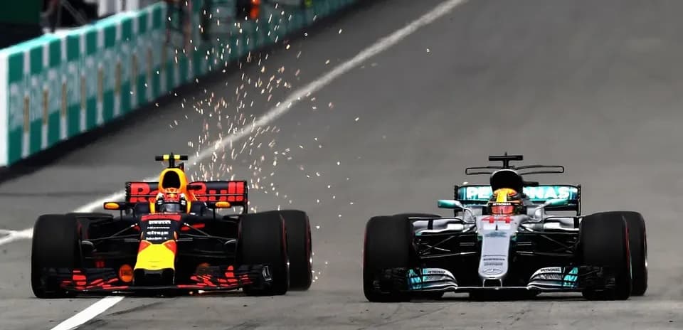 Red Bull and Mercedes cars racing closely on track