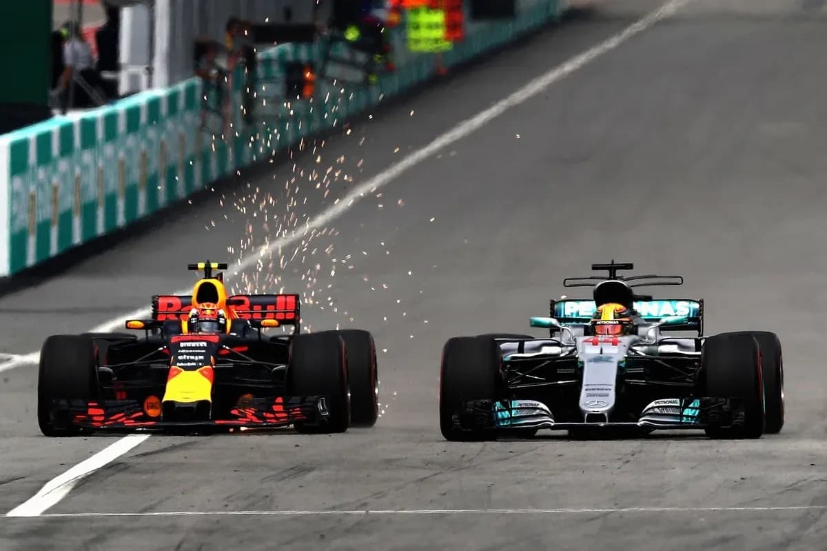 Red Bull and Mercedes cars racing closely on track