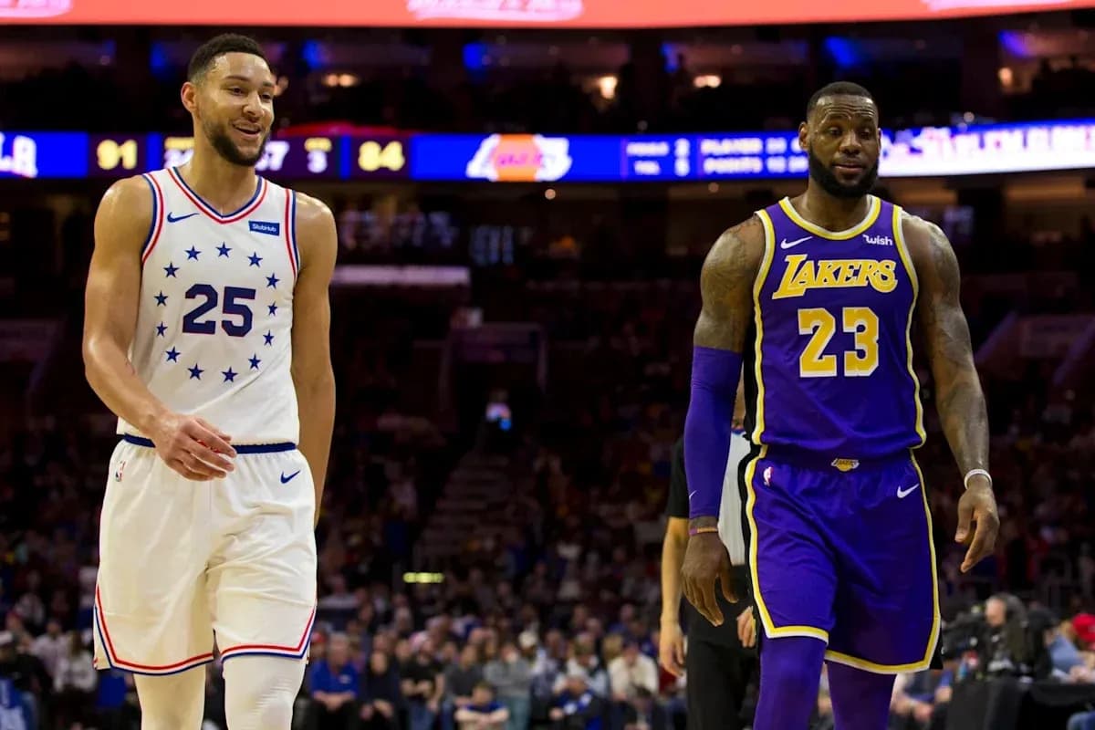 Two basketball players walking on court during game